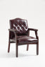 Front view of burgundy leather guest chair with button-tufted seat, padded arms, and mahogany-finish legs