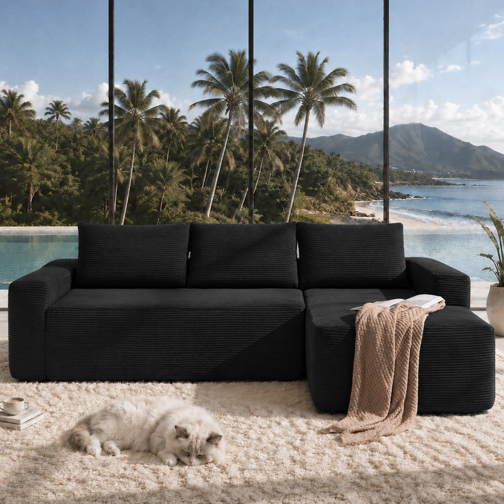 Angle view showing L-shaped configuration and corduroy texture of black sectional sofa