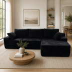 Angle view showing the L-shape and right-corner orientation of the black corduroy sofa