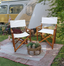 Front view of natural wooden folding director chair with canvas seat, standing on grass