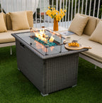 Glass wind guard installed around a rectangular fire table in outdoor setting