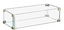 Front view of white-framed glass wind guard standing upright beside a fire table