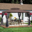 Front view of brown-topped 13 ft x 10 ft outdoor gazebo with mesh screens installed