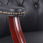 Close-up of button-tufted leather seat and padded armrest