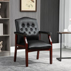 Front view of black leather guest chair with padded arms and button-tufted seat