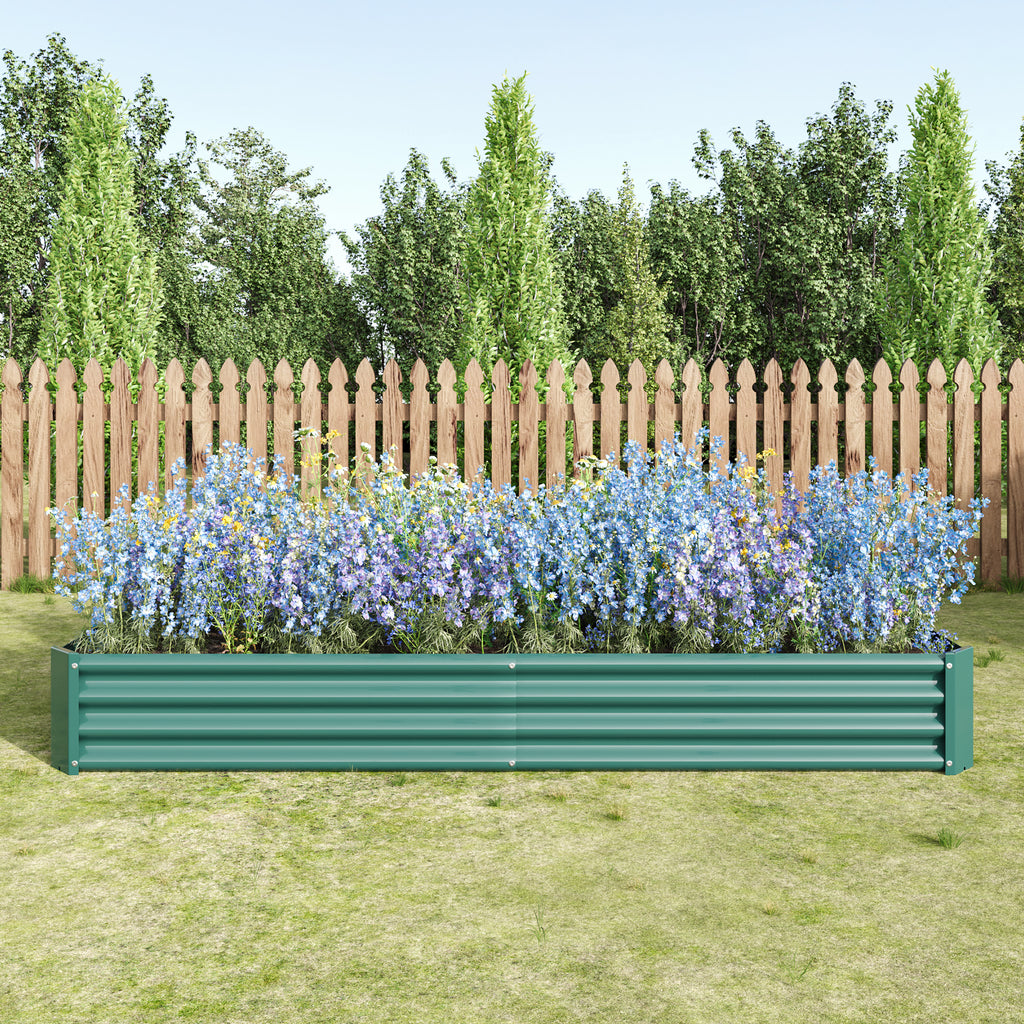 Green metal raised garden bed assembled in a backyard garden setting