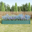 Green metal raised garden bed assembled in a backyard garden setting