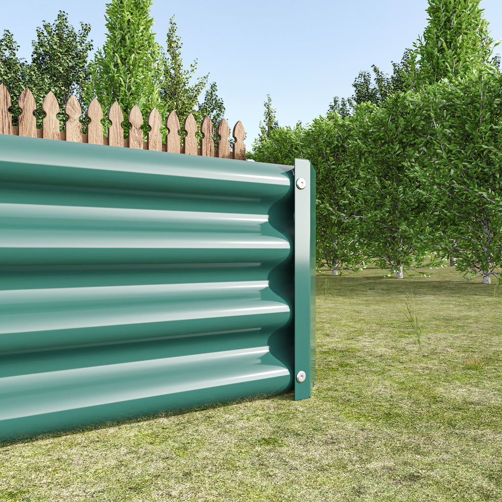 Green metal raised garden bed installed in soil with plants