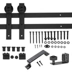 Front view of black sliding barn door hardware kit showing rail, hangers, and accessories laid out on a clean surface