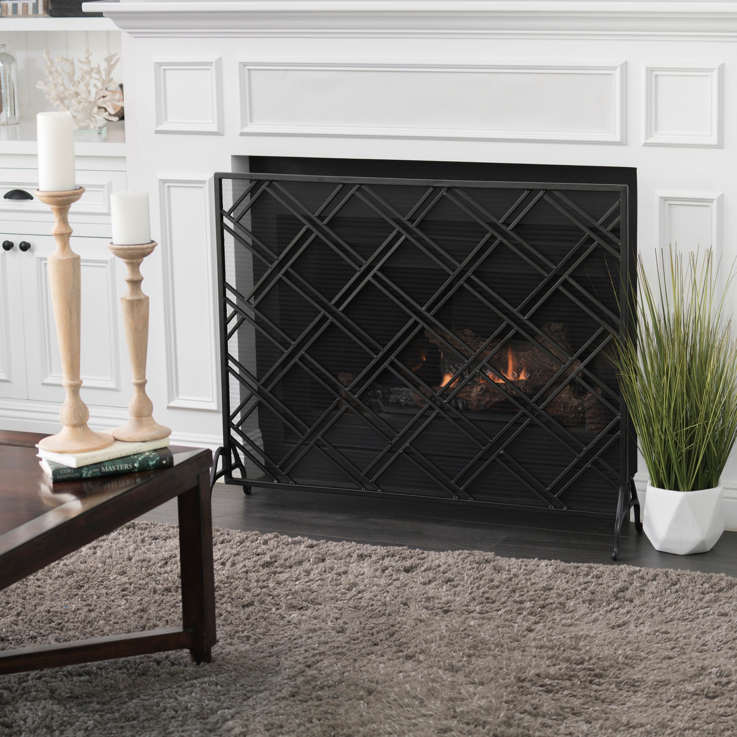 Front view of black iron fireplace fire screen showing scrollwork design and freestanding frame Main image