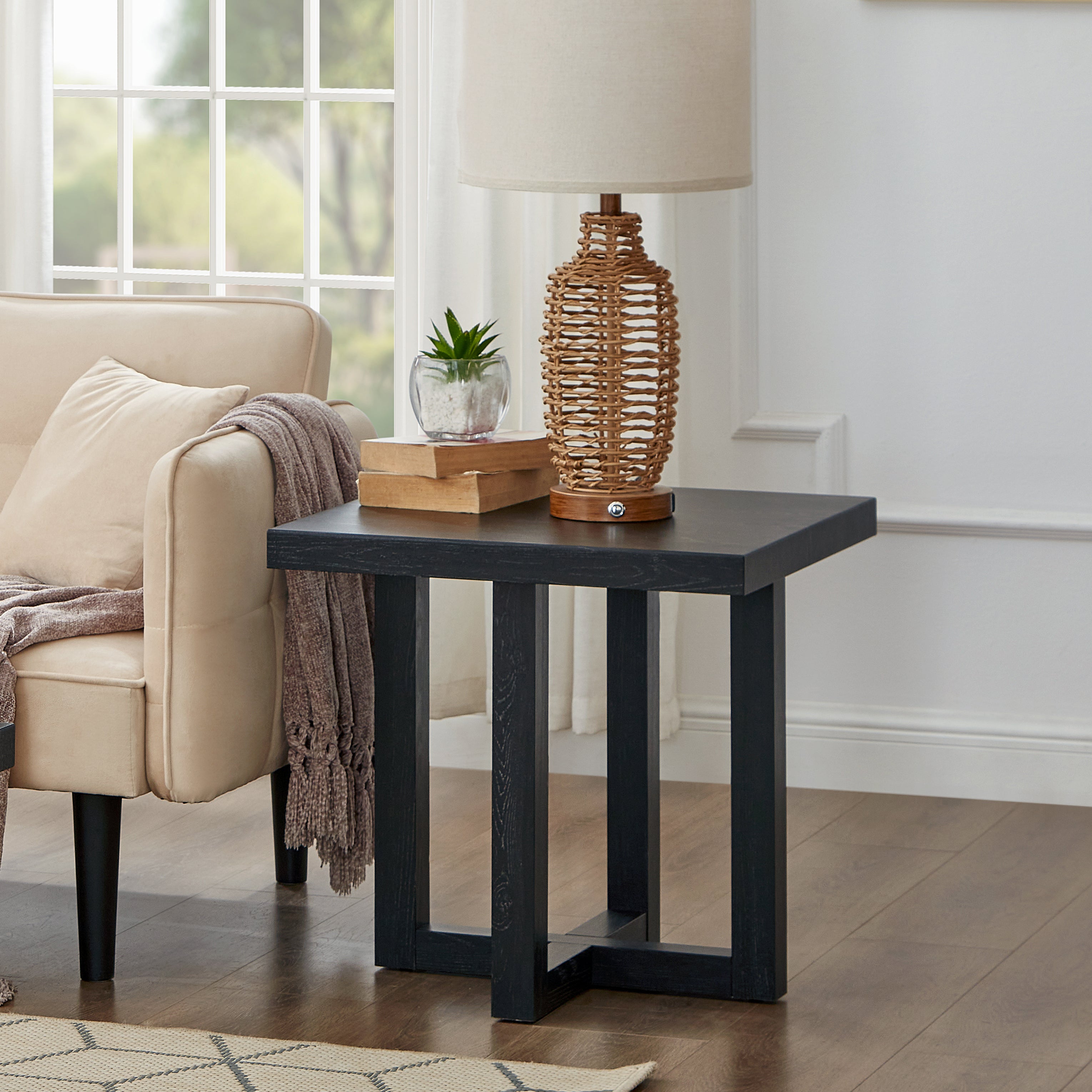 Luno Contemporary End Table in black shown in front view, highlighting rectangular top and intersecting base Main image