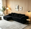 Front view of black corduroy frameless sectional sofa with L-shaped chaise