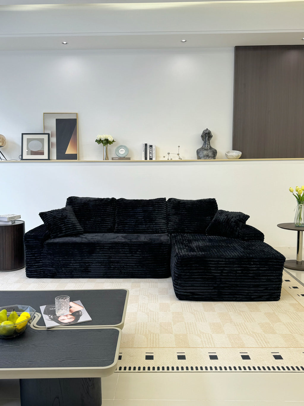 Close-up of black corduroy upholstery texture on the sofa seat