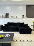 Close-up of black corduroy upholstery texture on the sofa seat