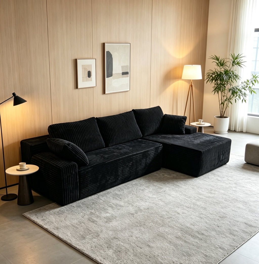 Front view of a black L-shaped corduroy sofa with right-corner configuration