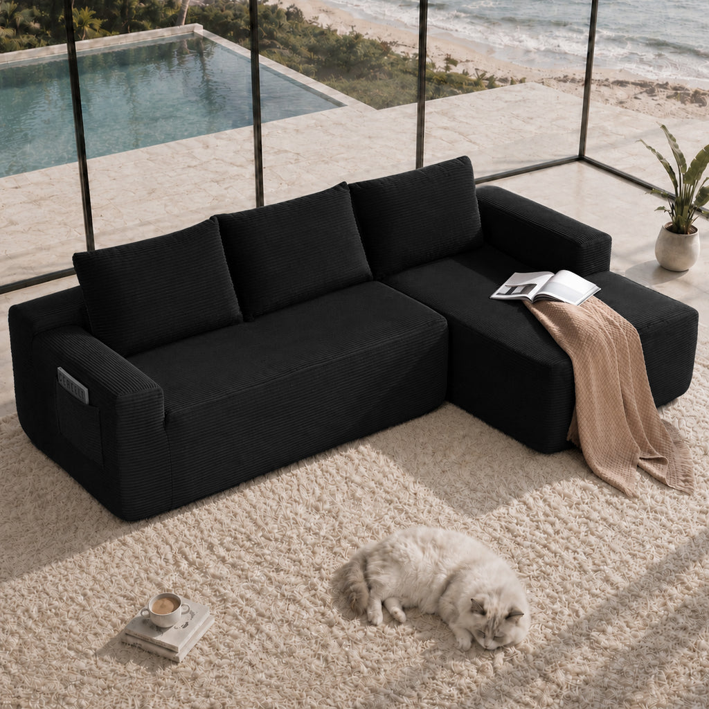 Front view of black corduroy 104-inch sectional sofa with L-shaped chaise and side pockets